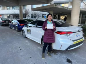 Driving instructor Mississauga congratulates student with new license, Hurontario area.