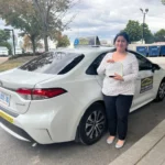 Student holding license after driving lessons Oakville, West Oakville.