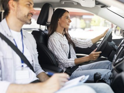 Confident young lady passing exams at driving school